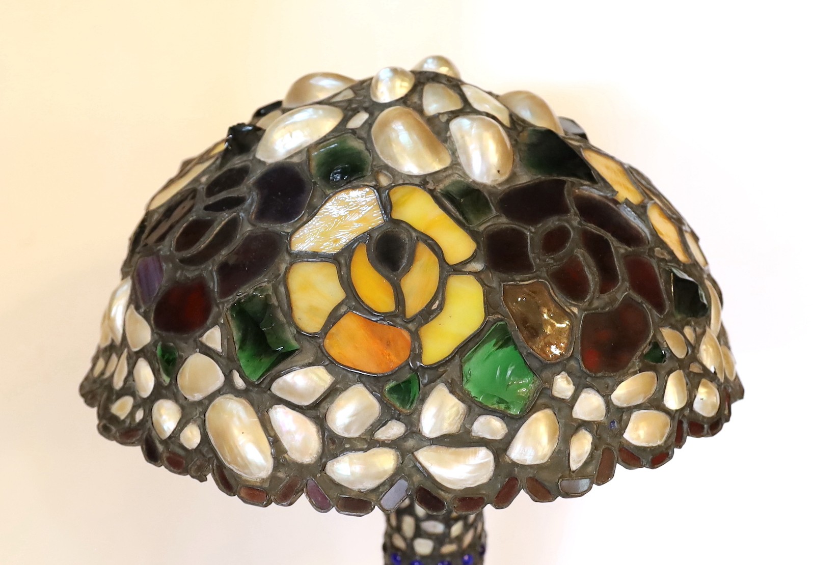 A 1920s Austrian stained glass and mother-of-pearl table lamp with domed shade, height 48cm